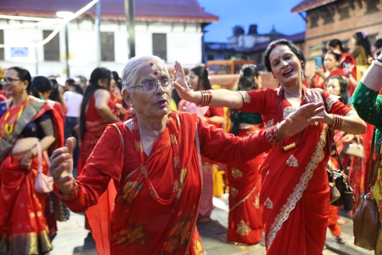 Women gather at the sacred Pashupatinath Temple, singing and dancing with joy.