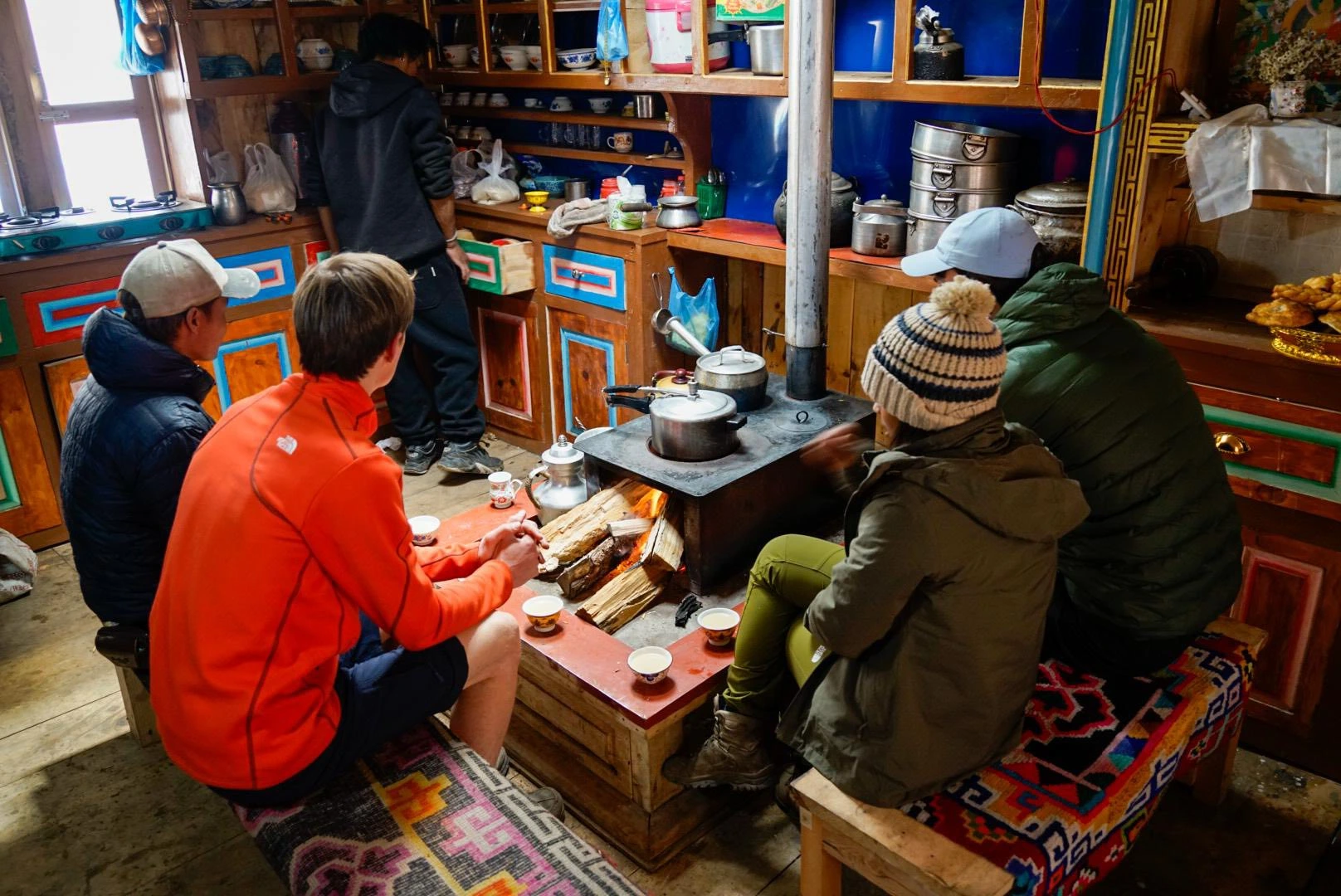 Trekkers taking short break to recharge in cozy tea house on Namslu Circuit Trek trail. 
