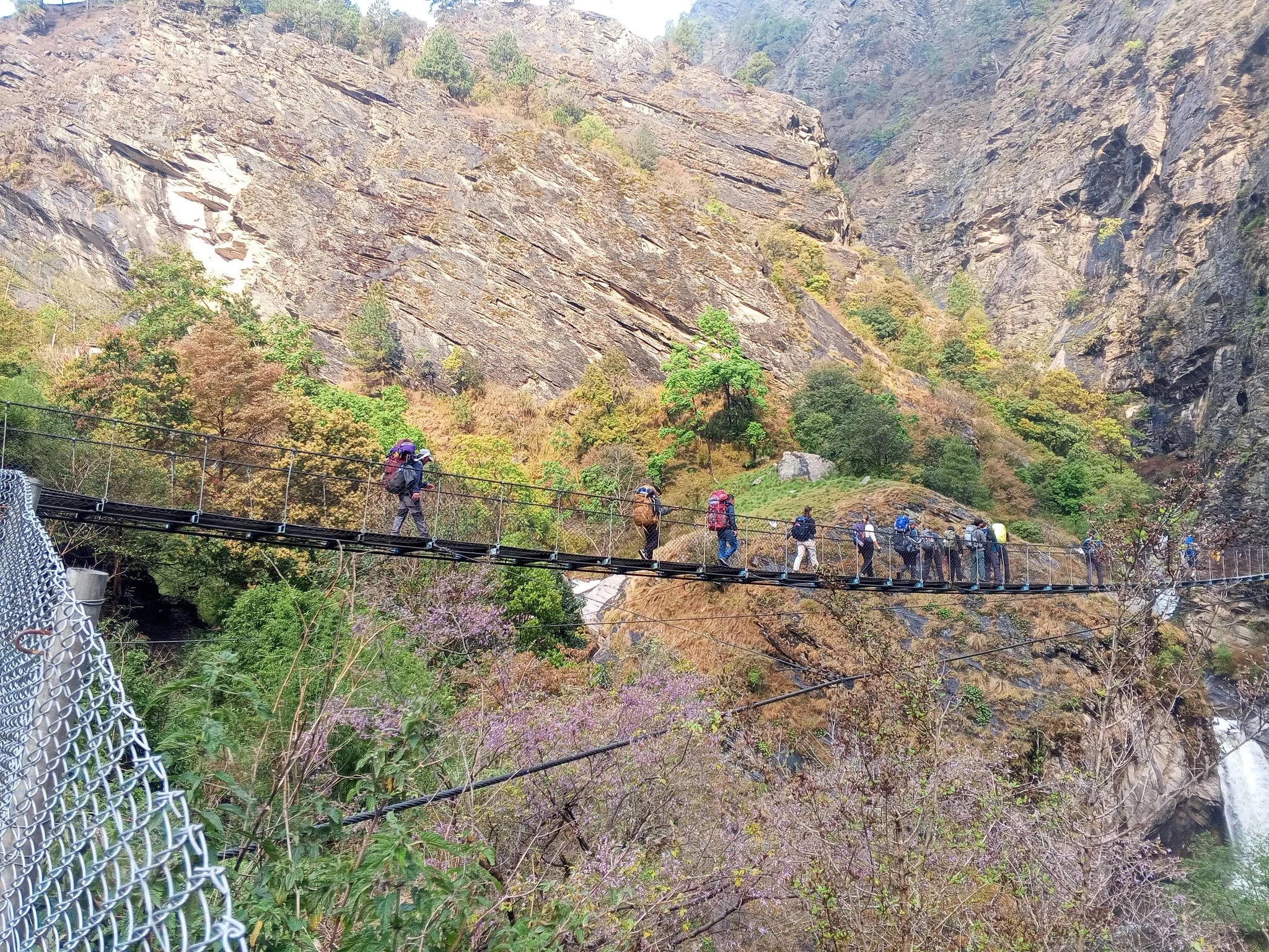  Trekking group enjoying the walking the suspension bridge in Manaslu Circuit trek trial 
