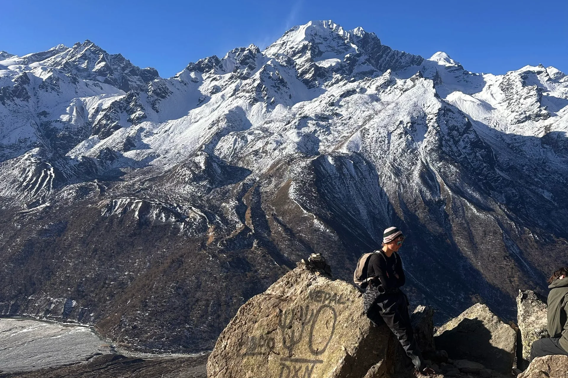 Trekkers enjoying mountain views near Kyanjin Ri on the Langtang Valley Trek
