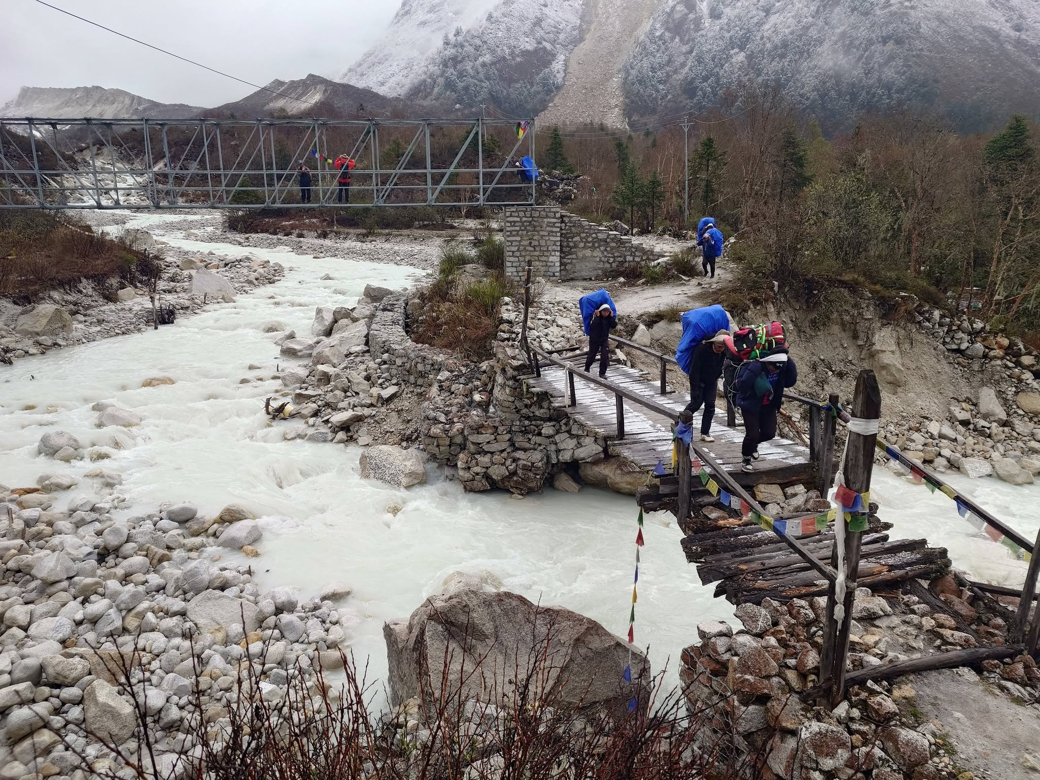 Guide leading trekkers through Manaslu village trail from dharapani to bhimthang in manaslu circuit trek