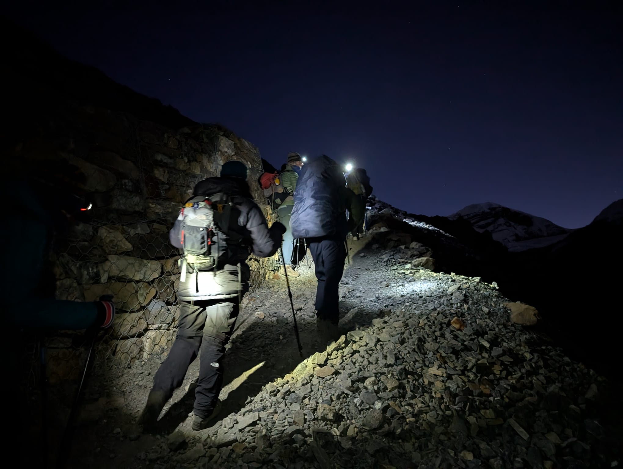 Trekkers walking toward thorong la pass on annapurna circuit trek trail